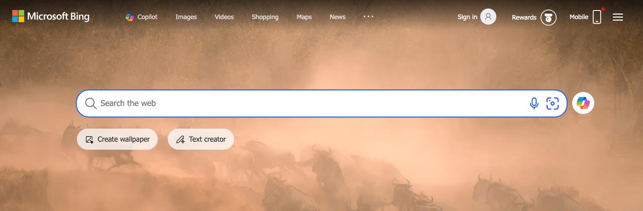 Bing homepage with the Copilot AI icon in the search bar and Create Wallpaper and Text Creator quick-action chips